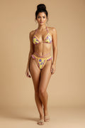 Woman wearing a colorful bikini with a neutral background