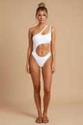 Woman wearing a white swimsuit against a plain background