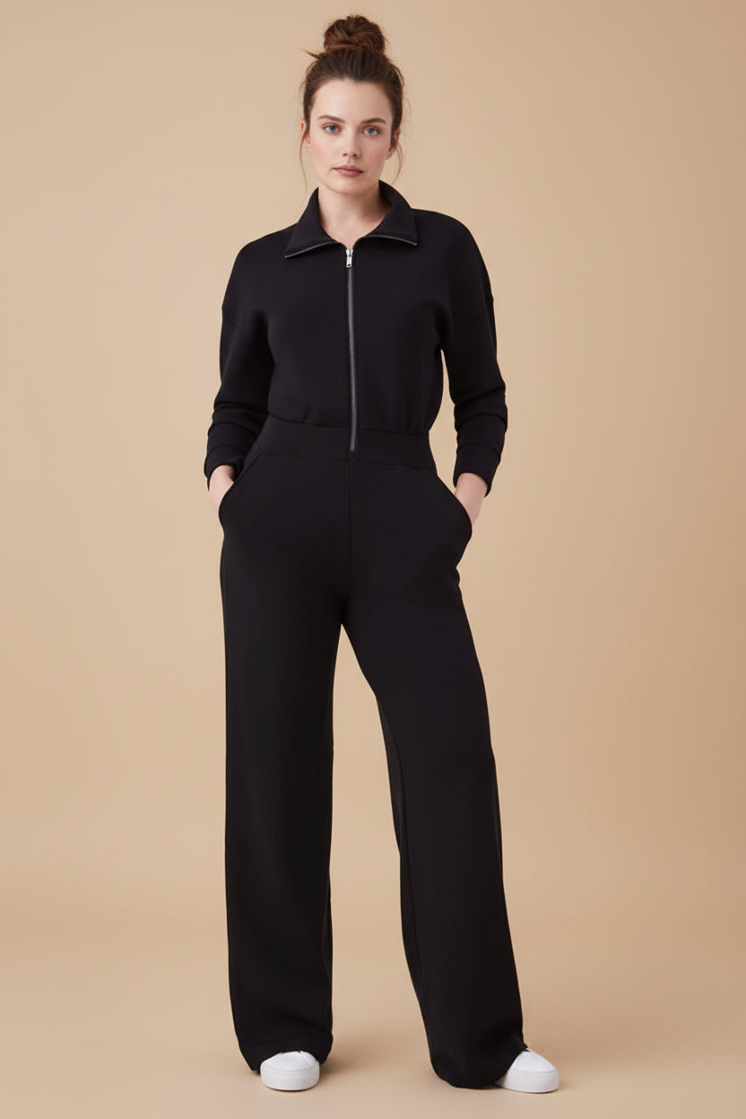 Person wearing a black jumpsuit on a white background