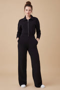 Person wearing a black jumpsuit on a white background