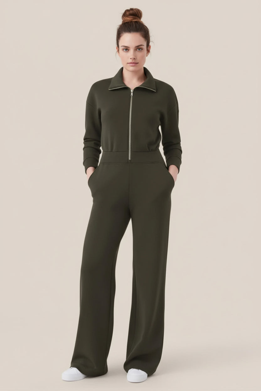 Person wearing a green jumpsuit on a beige background