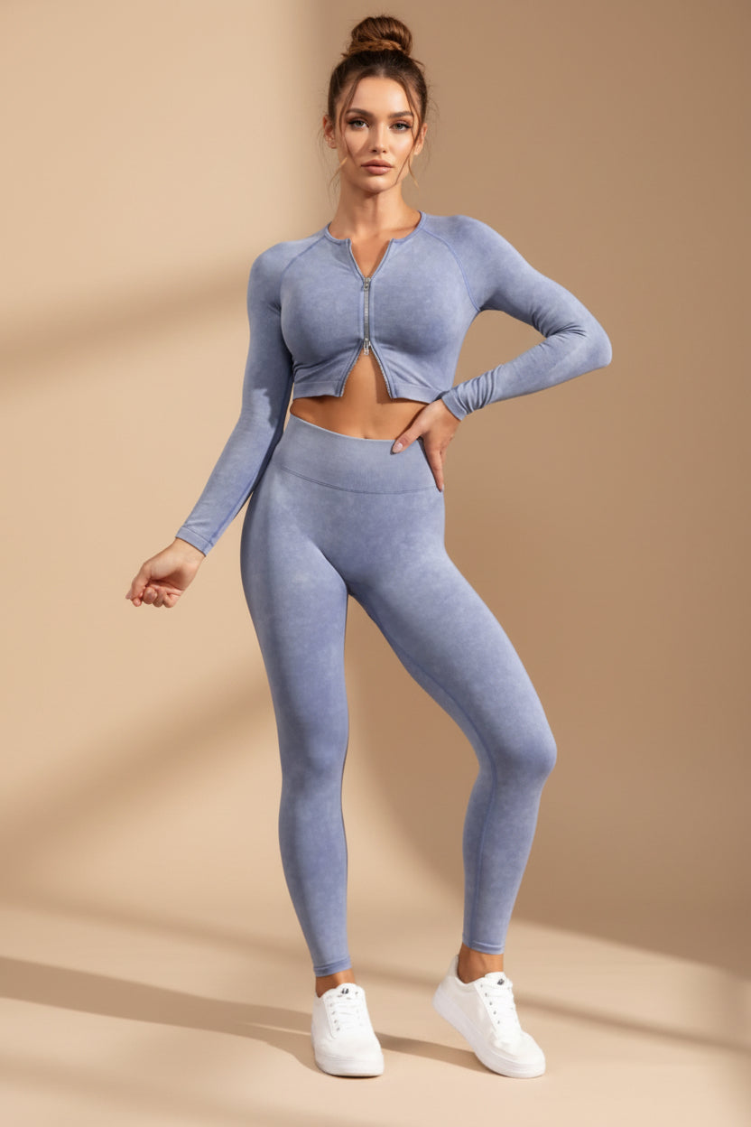 Woman wearing a blue athletic outfit standing against a gray background