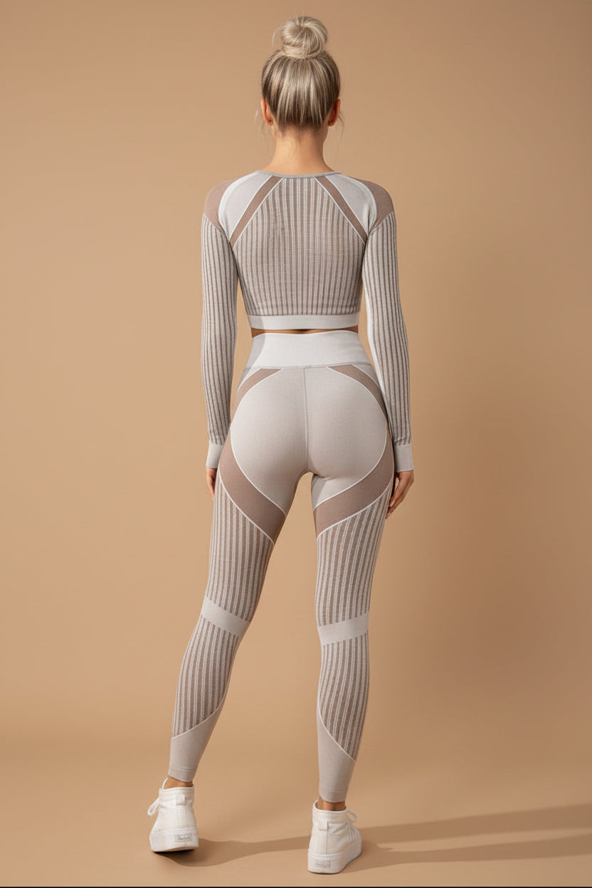 Woman wearing a gray and beige patterned athletic outfit on a white background