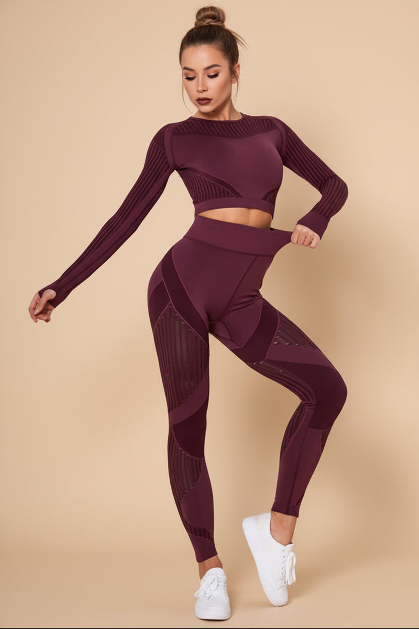 Woman wearing a maroon athletic outfit on a white background