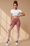 Pink leggings worn by a person on a white background